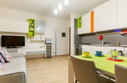 Le Cure Apartment | GuestHost - Comfortable 50sqm apartment with tiled patio that can accommodate up to 4 people. Located on the ground floor of a modern building of recent construction, the apartment is equipped with private parking space for a motorbike (inside the patio)