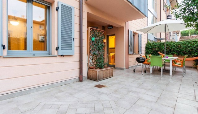 GuestHost - Comfortable 50sqm apartment with tiled patio that can accommodate up to 4 people. Located on the ground floor of a modern building of recent construction, the apartment is equipped with private parking space for a motorbike (inside the patio)